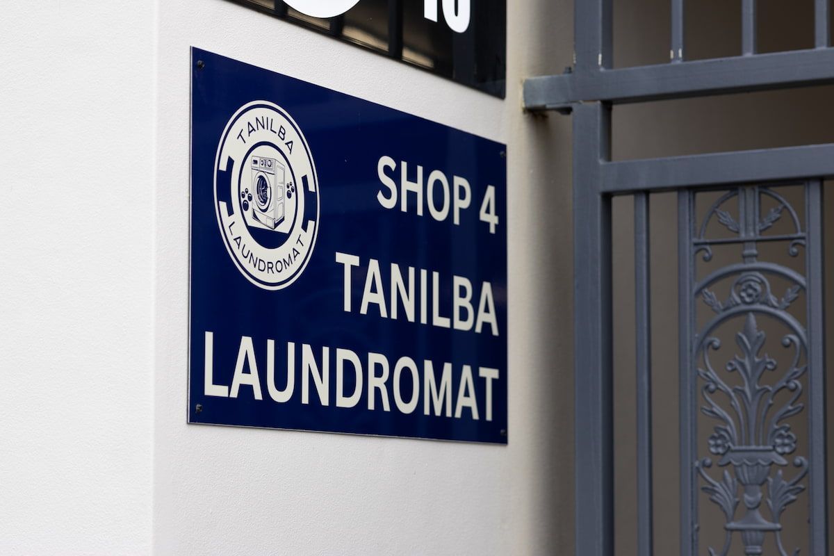 A Blue Sign That Says Shop 4 On It — Tanilba Bay Laundromat In Tanilba Bay, NSW
