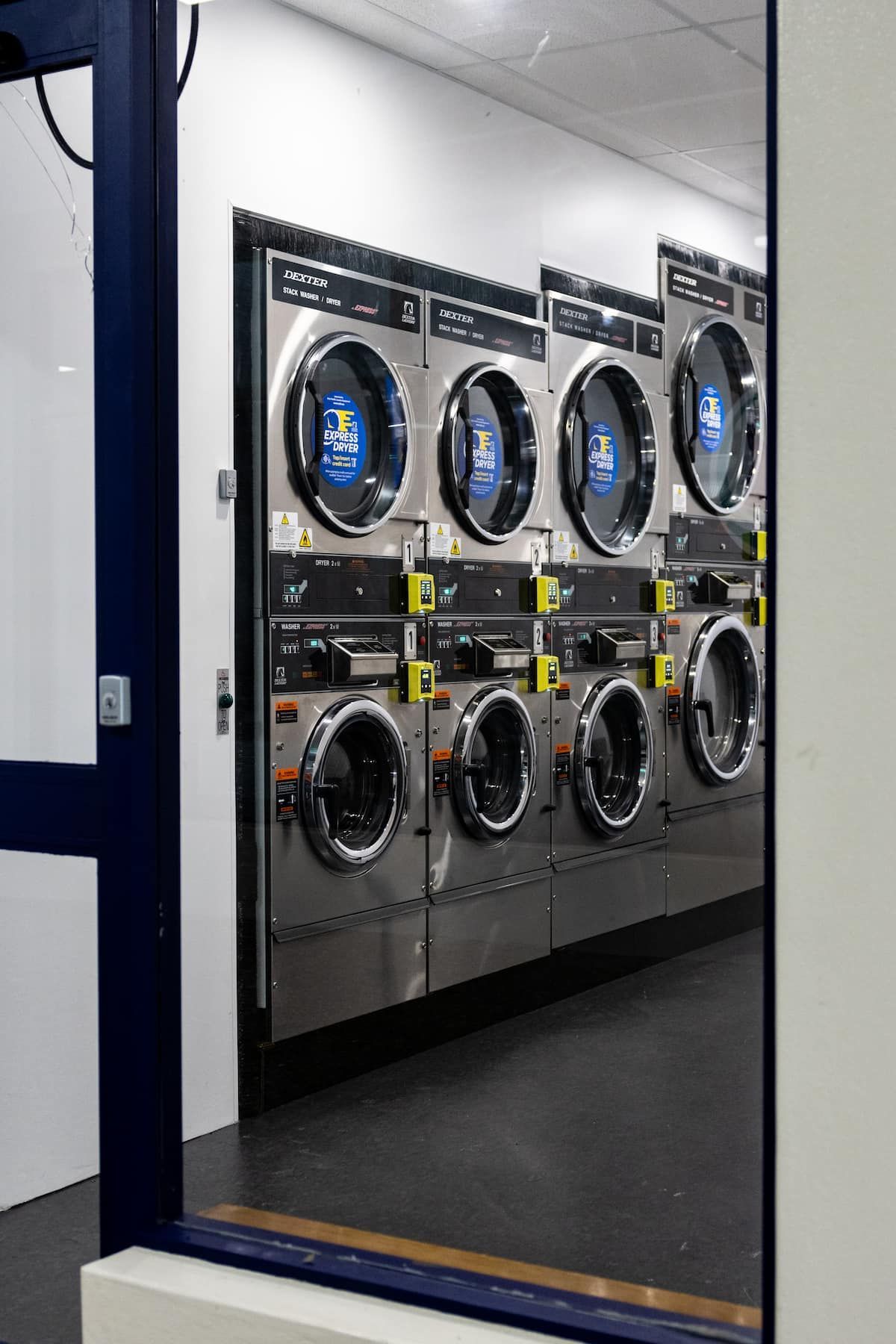 A Row Of Washing Machines Are Lined Up In A Laundromat — Tanilba Bay Laundromat In Tanilba Bay, NSW