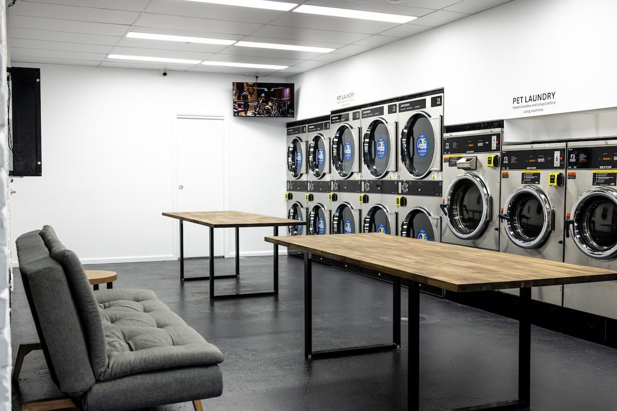 A Laundromat With Lots Of Washing Machines And Tables — Tanilba Bay Laundromat In Tanilba Bay, NSW
