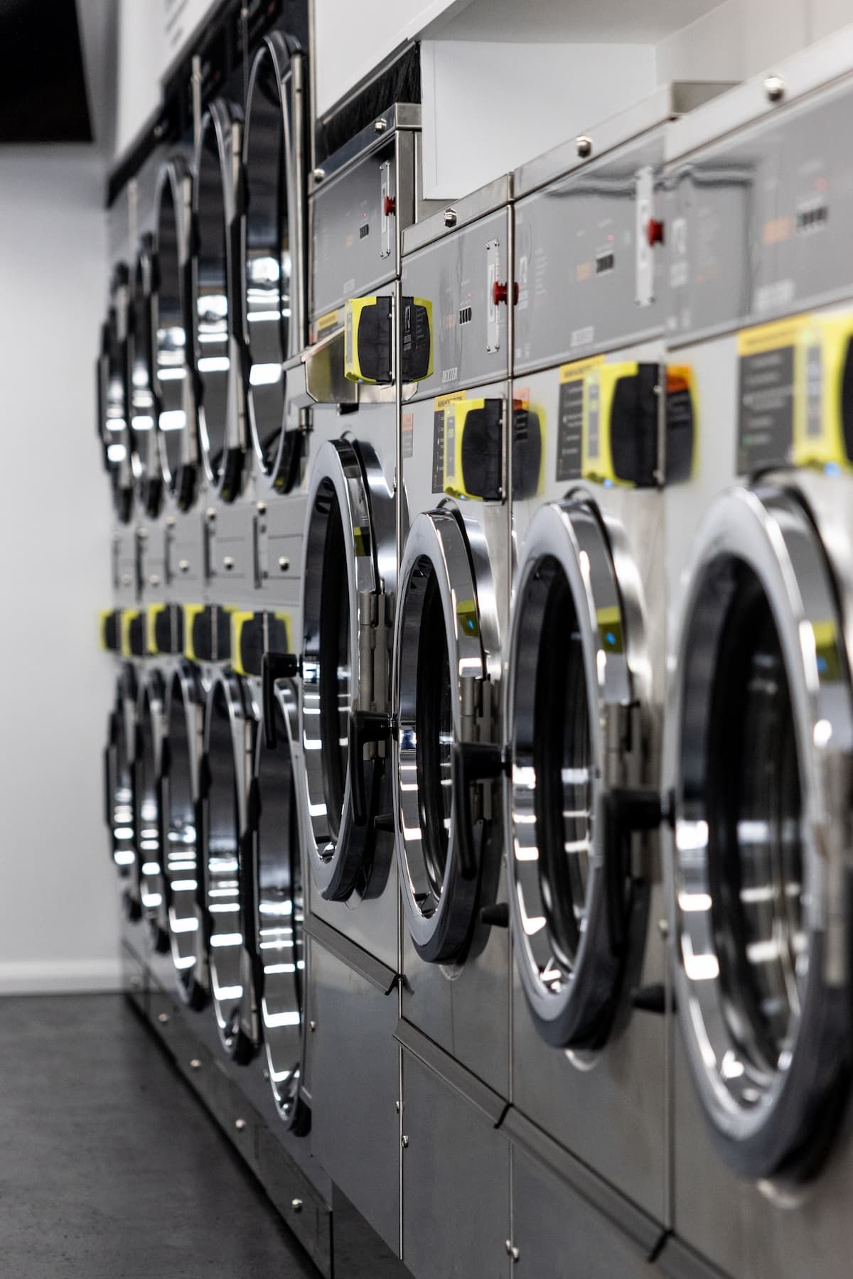 A Row Of Washing Machines Are Lined Up In A Laundromat — Tanilba Bay Laundromat In Anna Bay, NSW