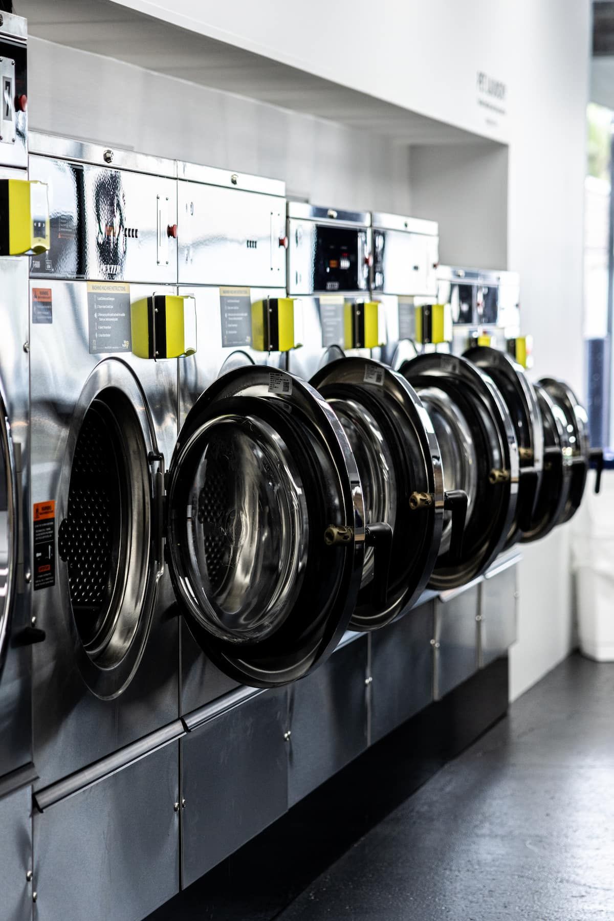 A Row Of Washing Machines Are Lined Up In A Laundromat — Tanilba Bay Laundromat In Tanilba Bay, NSW