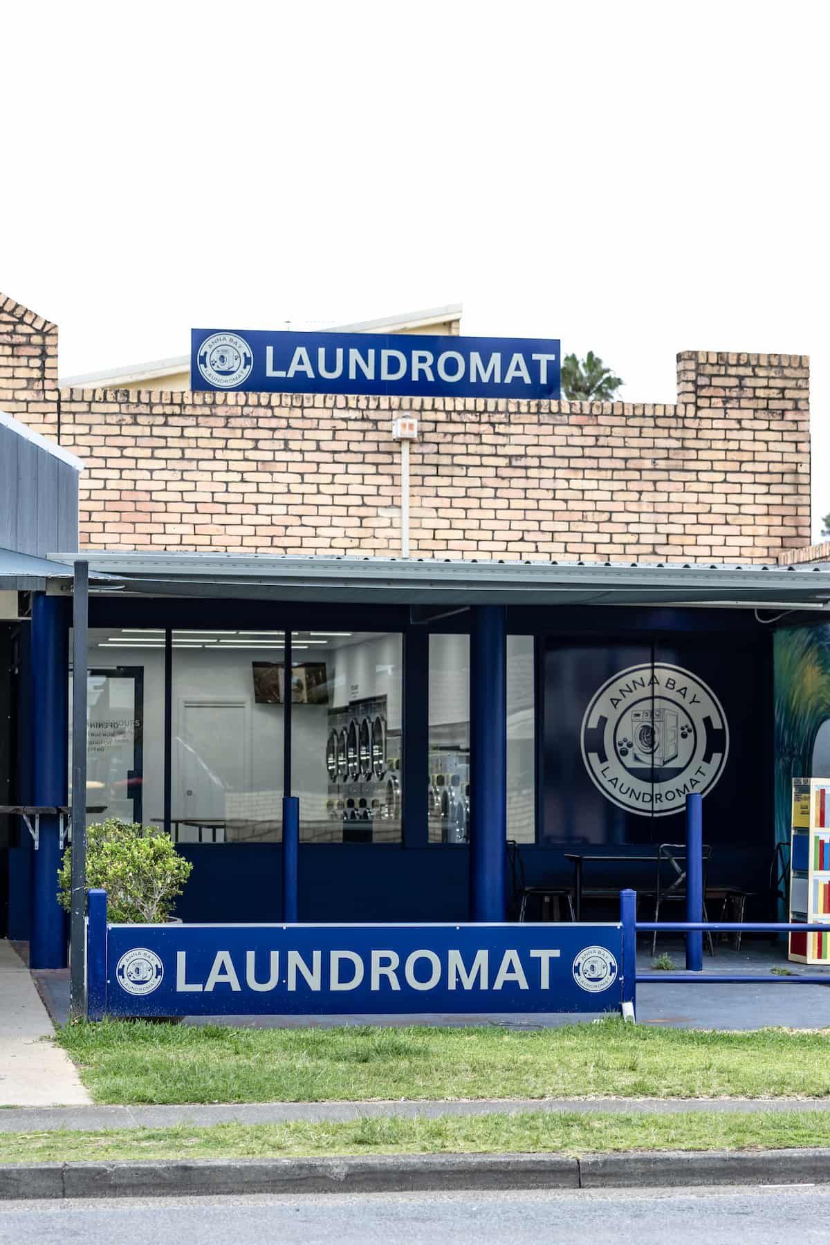 A Laundromat Is Located On The Side Of The Road Next To A Brick Building — Tanilba Bay Laundromat In Anna Bay, NSW