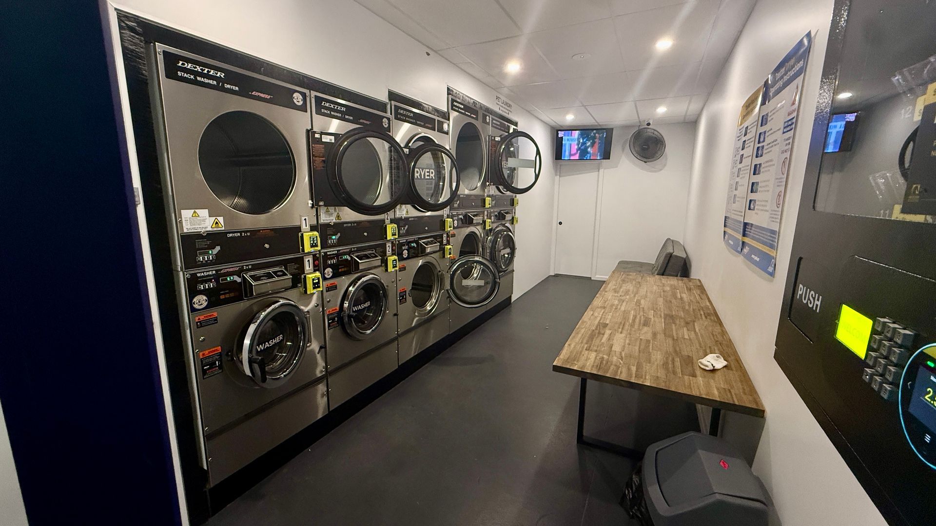 inside the laundromat with machine doors open— Tanilba Bay Laundromat In Tanilba Bay, NSW