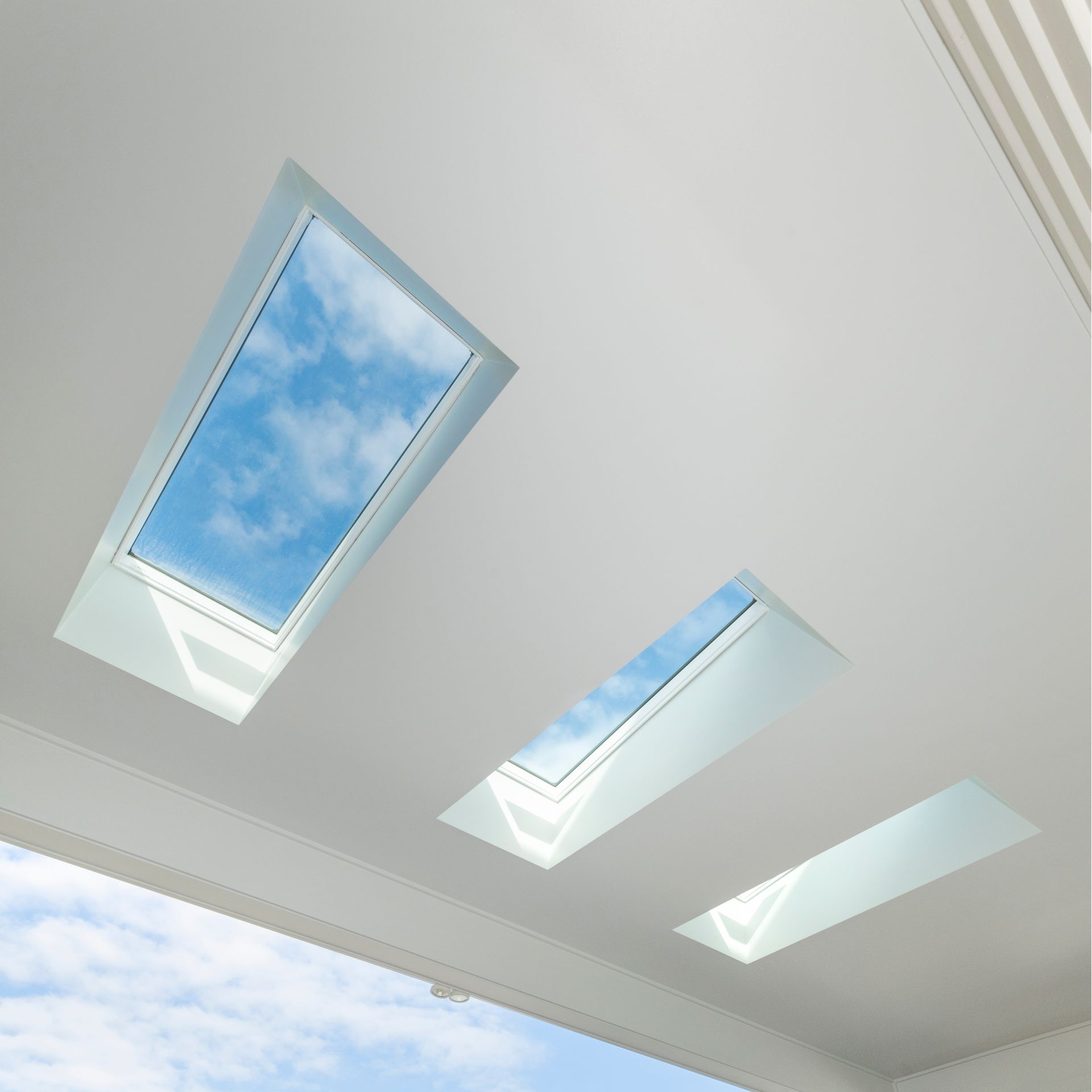 Three Rectangular Skylights in a White Ceiling, Showing a Blue Sky With Clouds — Indie Living In Lake Macquarie, NSW