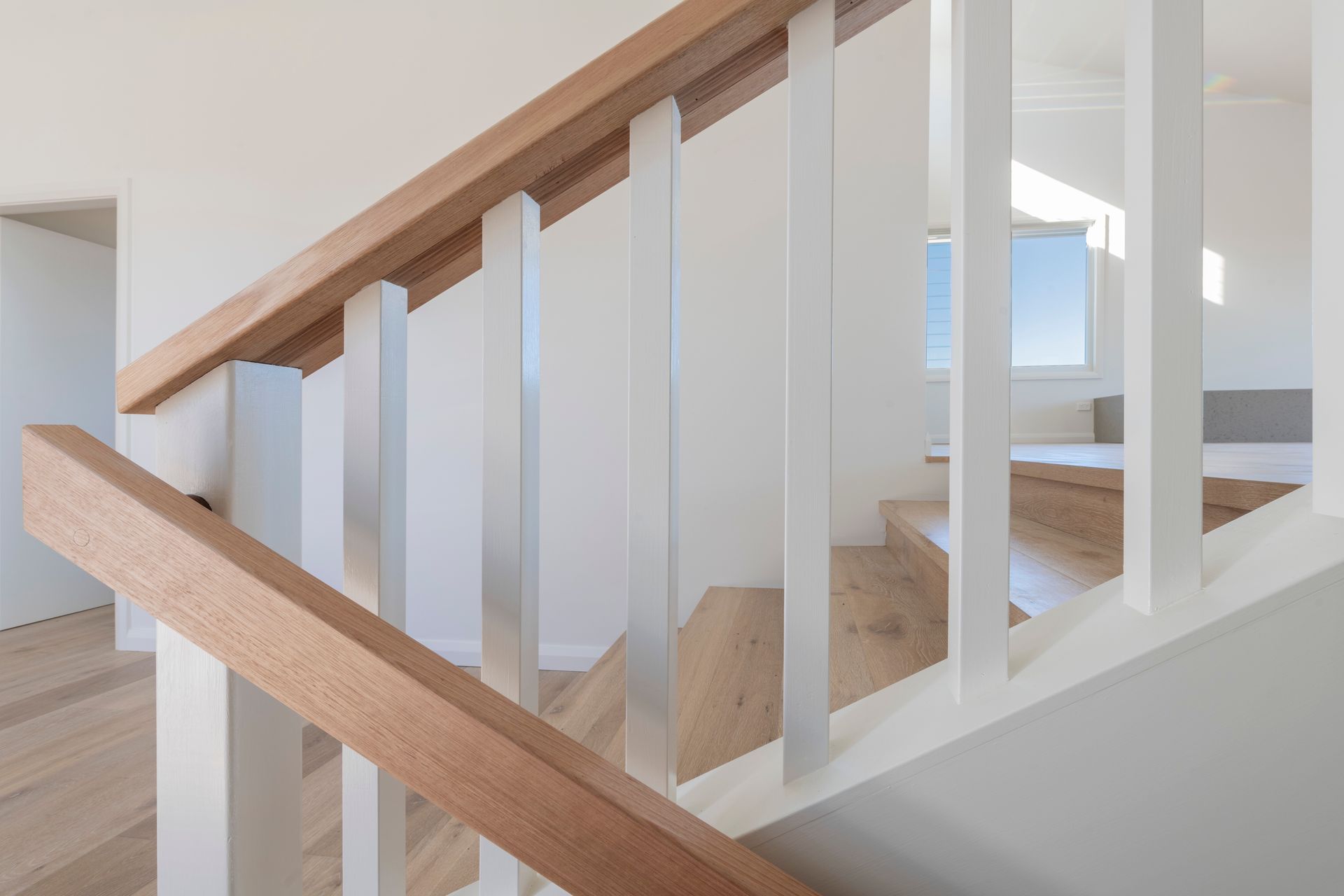 Wooden Handrails With White Posts on Stairs in a Bright, and Modern Home — Indie Living In Lake Macquarie, NSW
