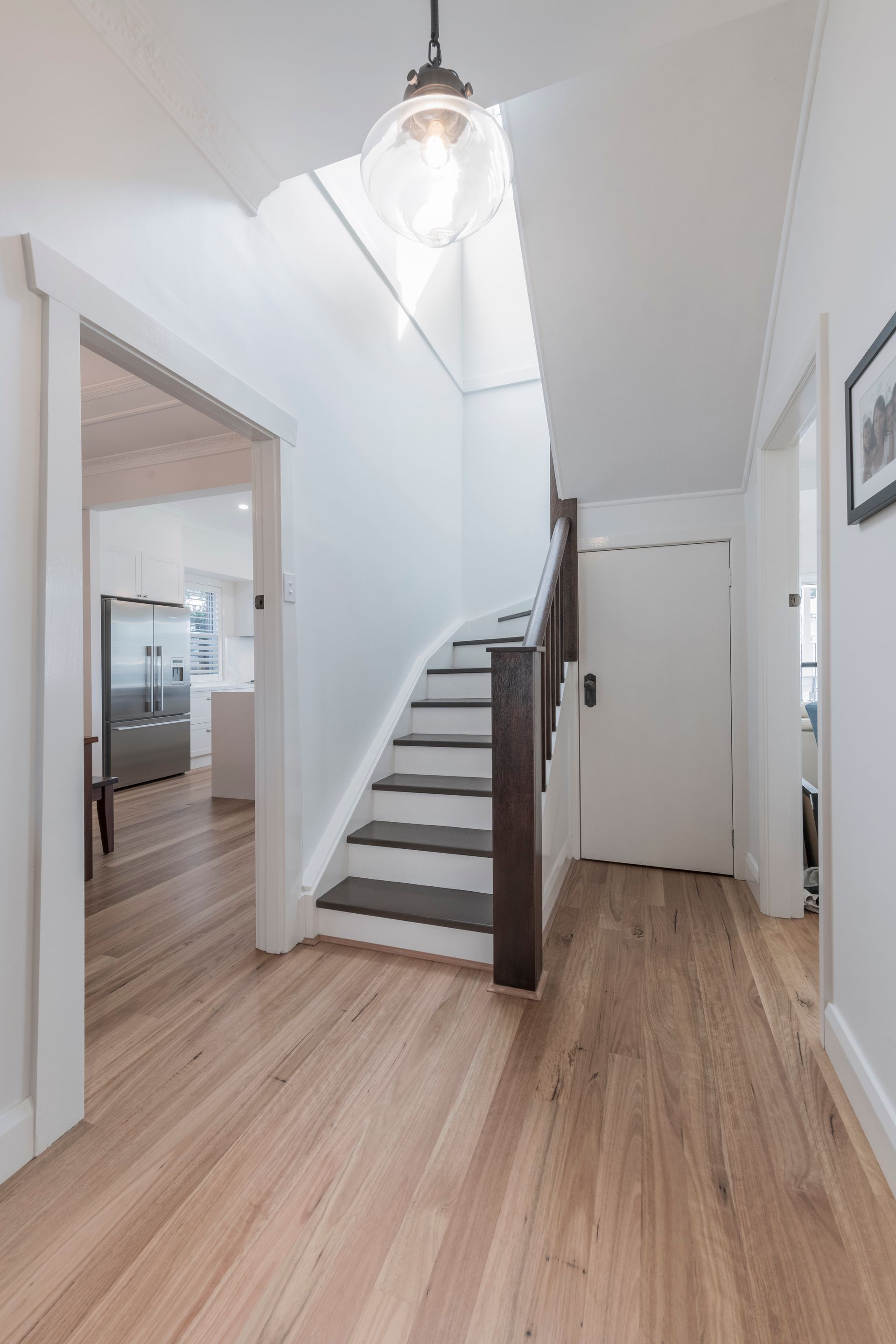 Wooden-Floored Hallway With a Staircase and Doorways — Indie Living In Lake Macquarie, NSW