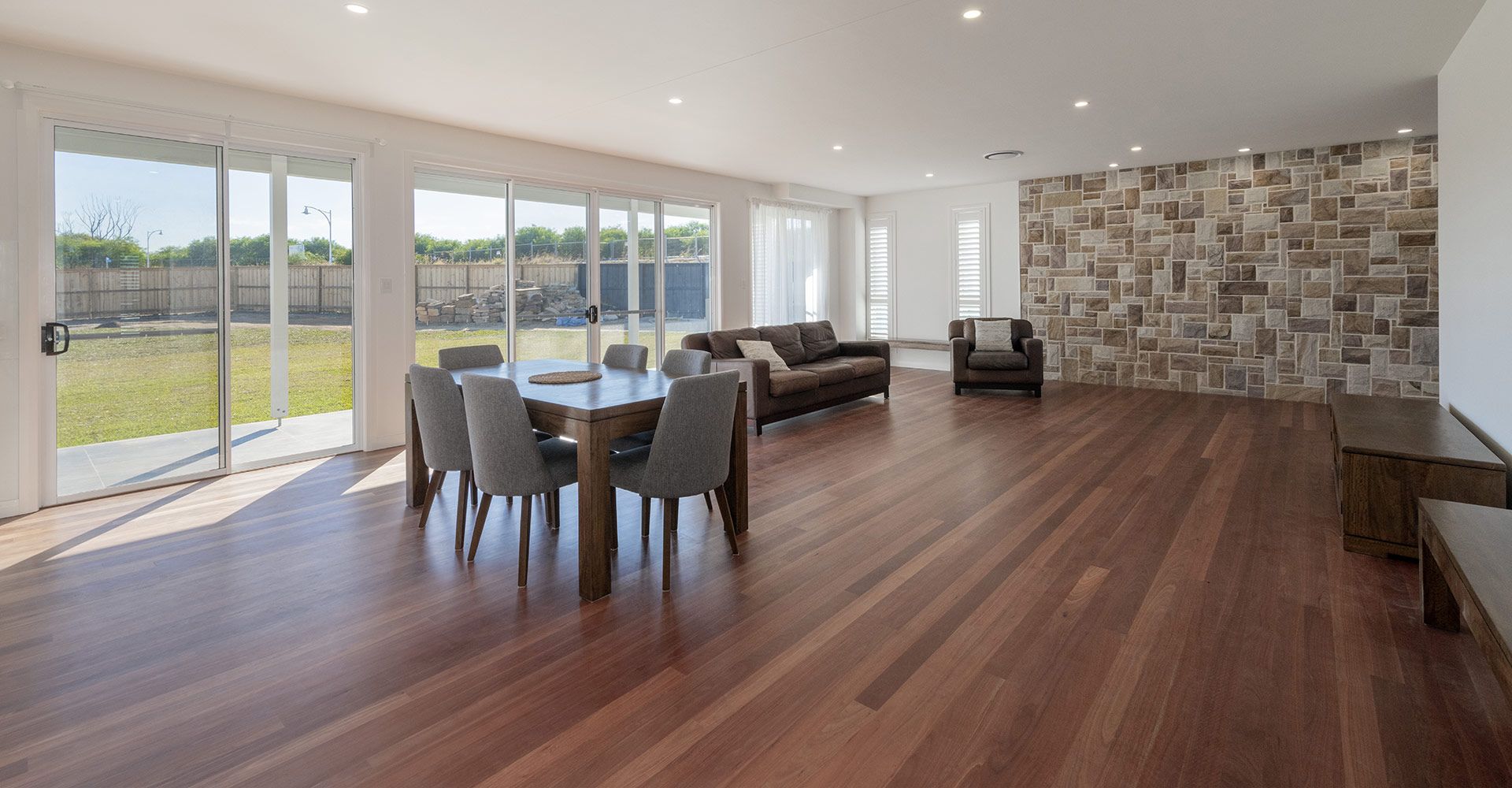 A Living Room With Hardwood Floors , a Dining Table and Chairs , and a Couch — Indie Living In Bennetts Green, NSW