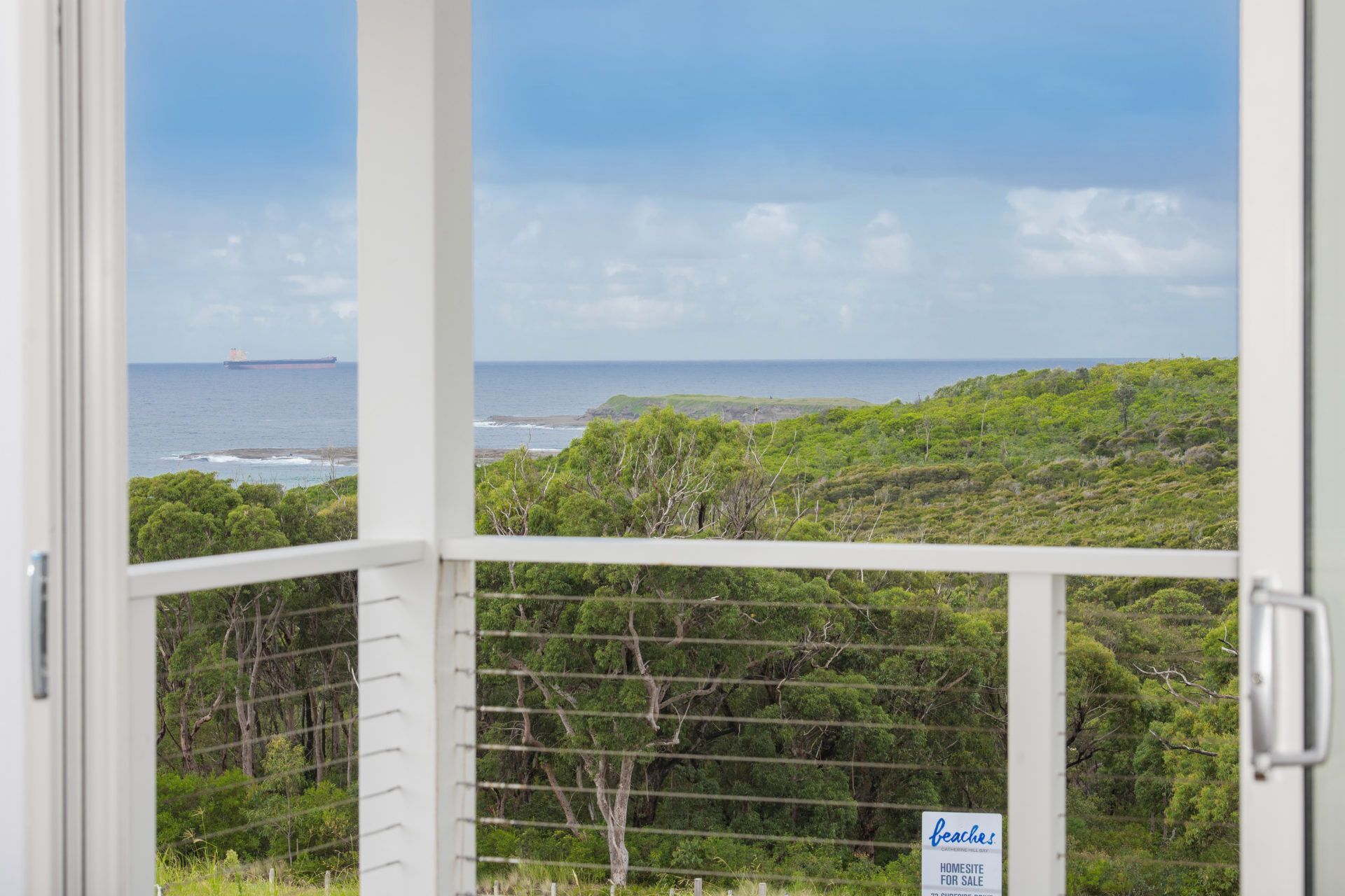 A Balcony With a View of the Ocean and Trees — Indie Living In Bennetts Green, NSW