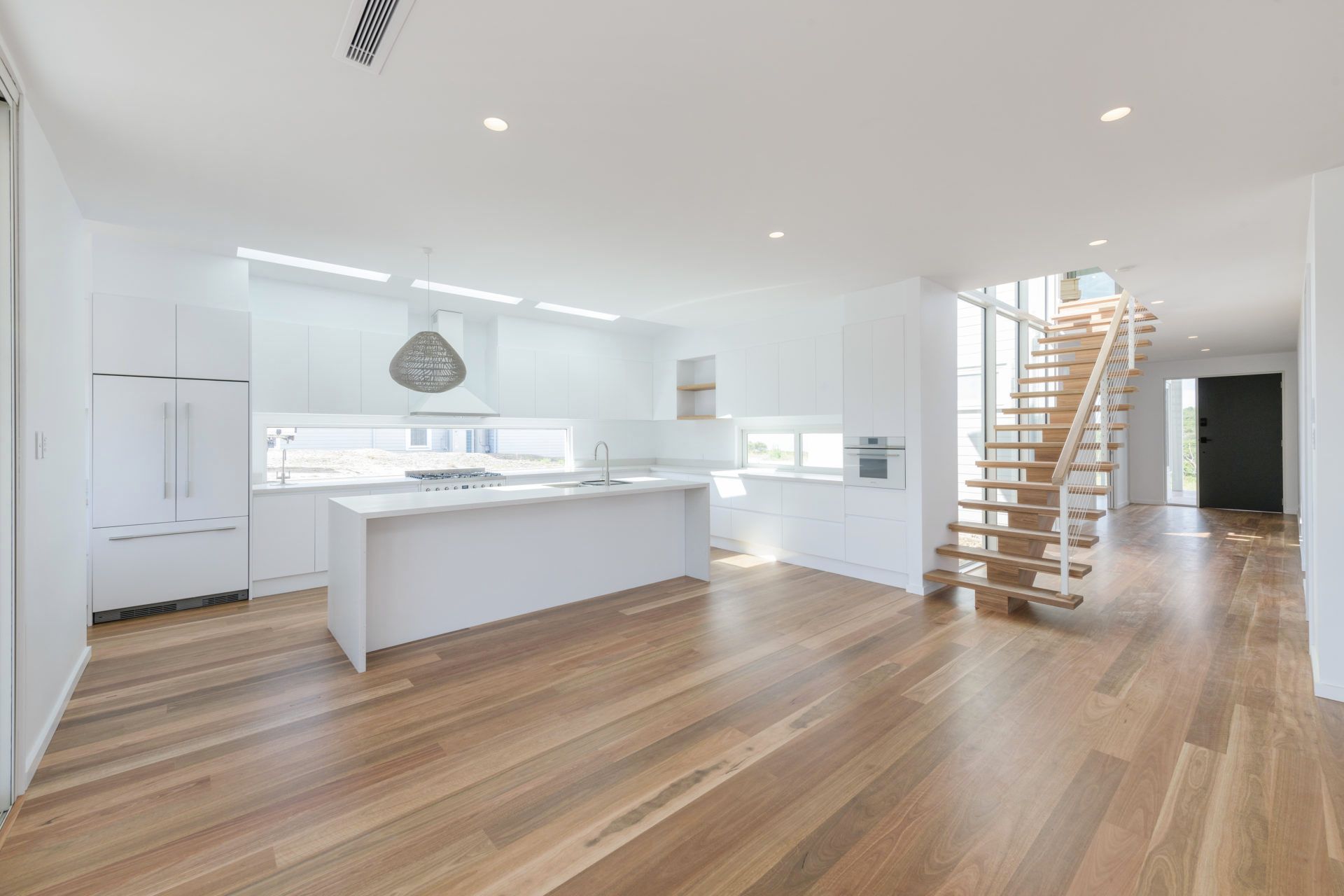A Kitchen With a Wooden Floor and Stairs in a House — Indie Living In Bennetts Green, NSW