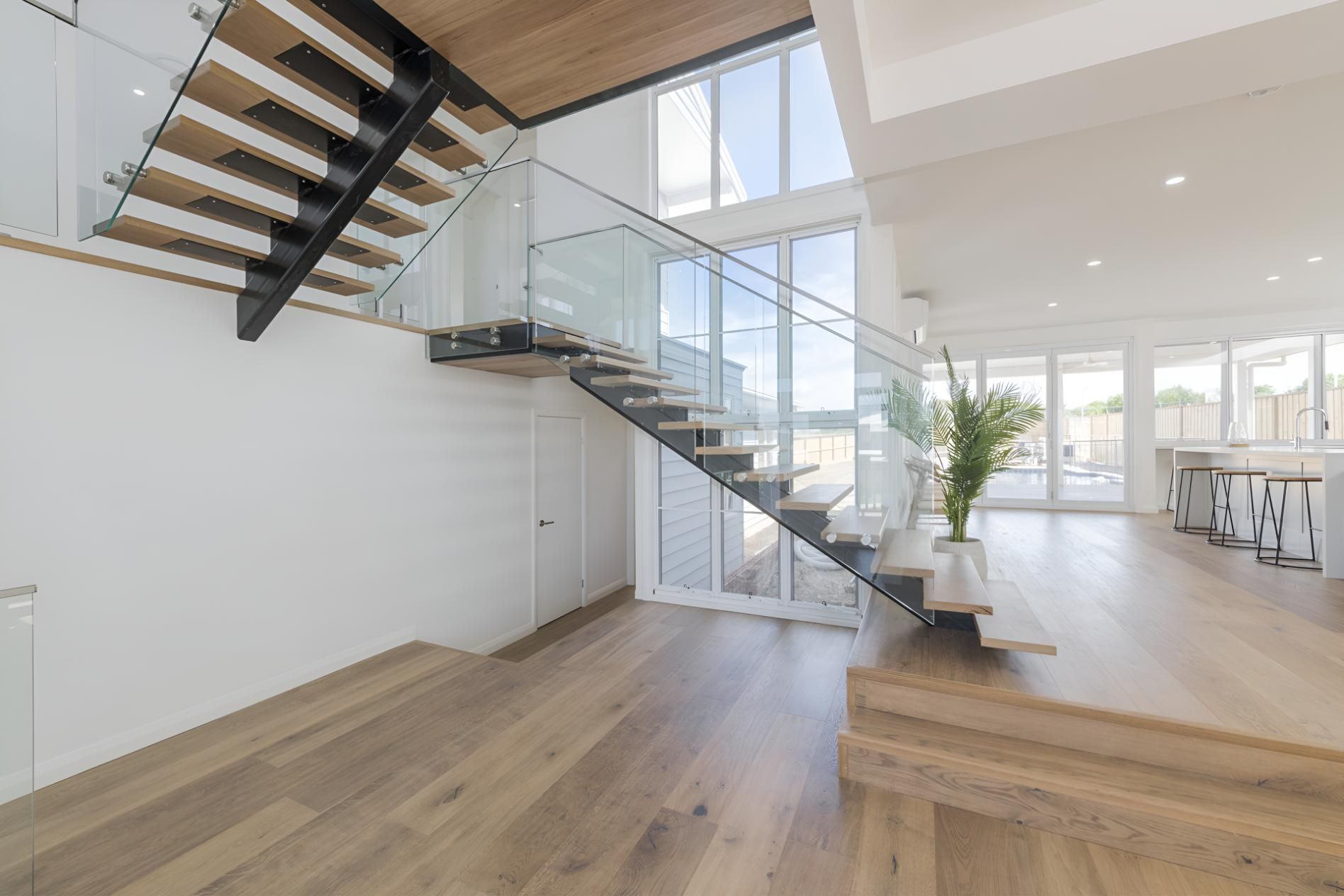 Staircase in the Middle of the Room With a Glass Railing — Indie Living In Bennetts Green, NSW