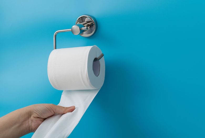 Hand on toilet roll