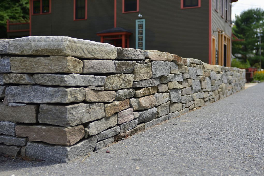 Ideas for working a stone wall into your landscaping project