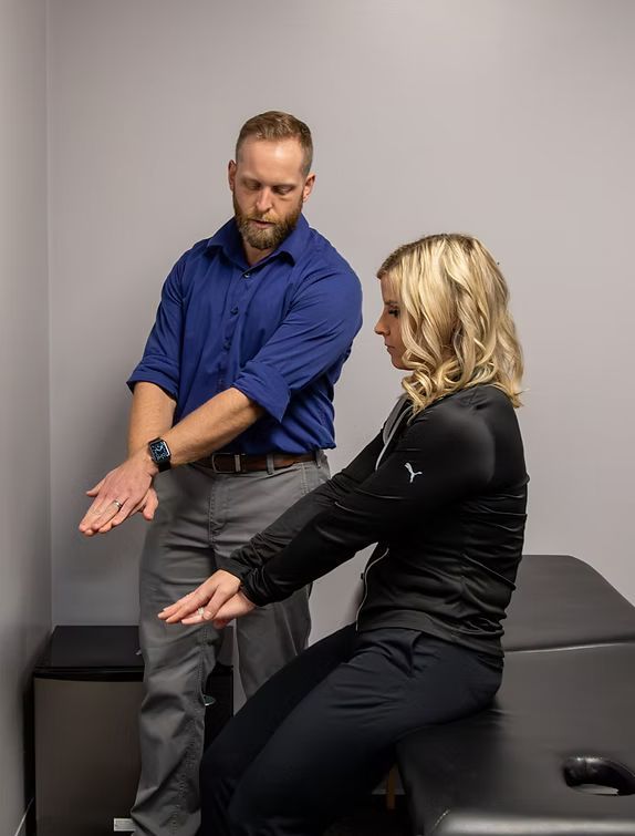 Dr. Condry explaining Postural Restoration exercises to a patient.