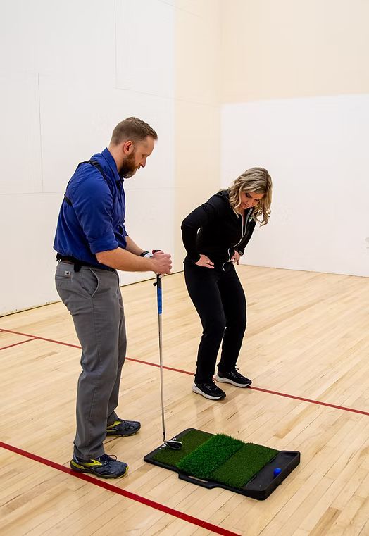 Dr. Tara explaining the correct posture for a good swing.