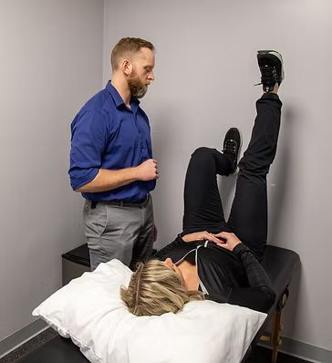 Dr. Evan Condry explains Postural Restoration exercises to a patient.