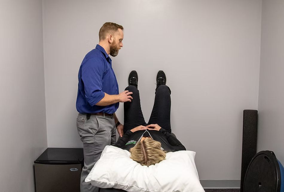 Dr. Evan Condry at a Postural Restoration session with a patient.