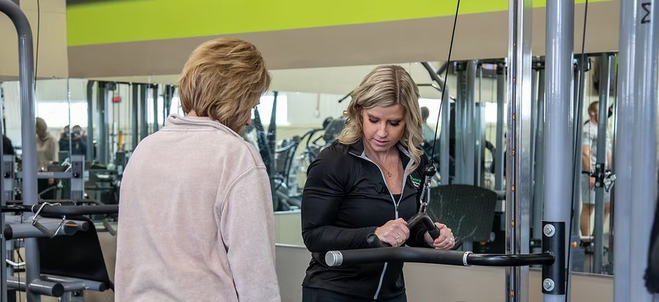 Dr. Tara Jaeger explains an exercise to a patient.