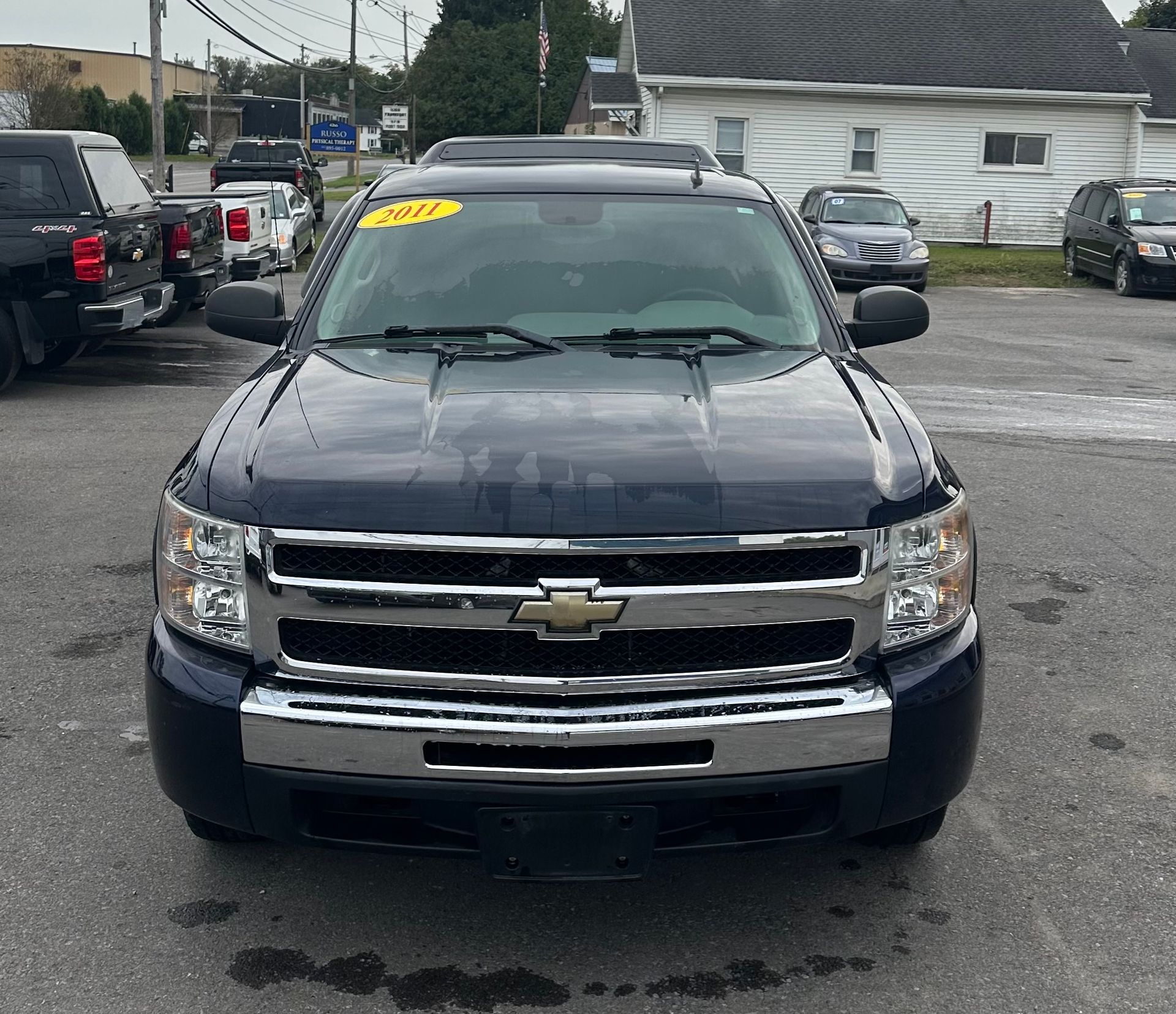 A black chevrolet truck is parked in a parking lot