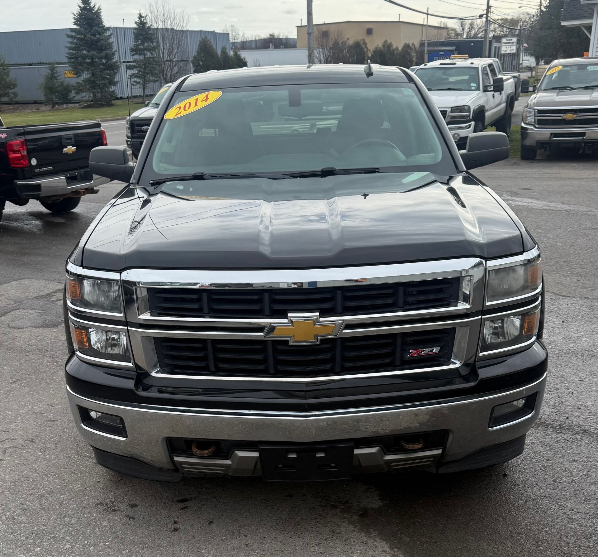 Black Chevrolet Silverado truck in a car lot.