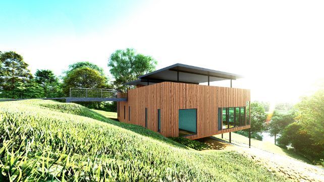 A Wooden House is Sitting on Top of a Grassy Hill Surrounded by Trees — Omni Builders In Bungalow, QLD