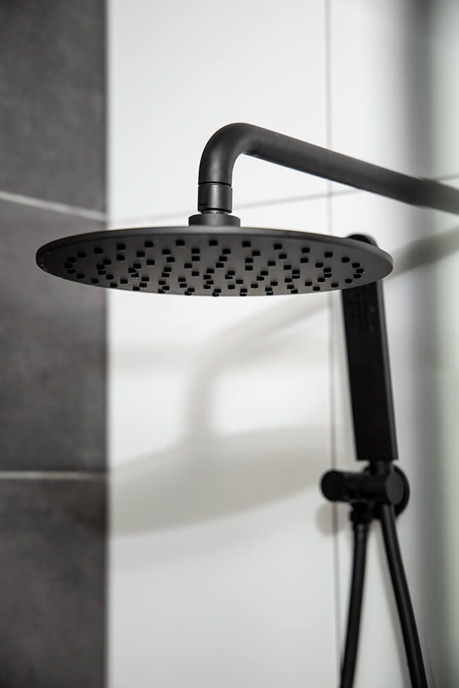 A bathroom with a bathtub and a shower — Omni Builders In Bungalow, QLD