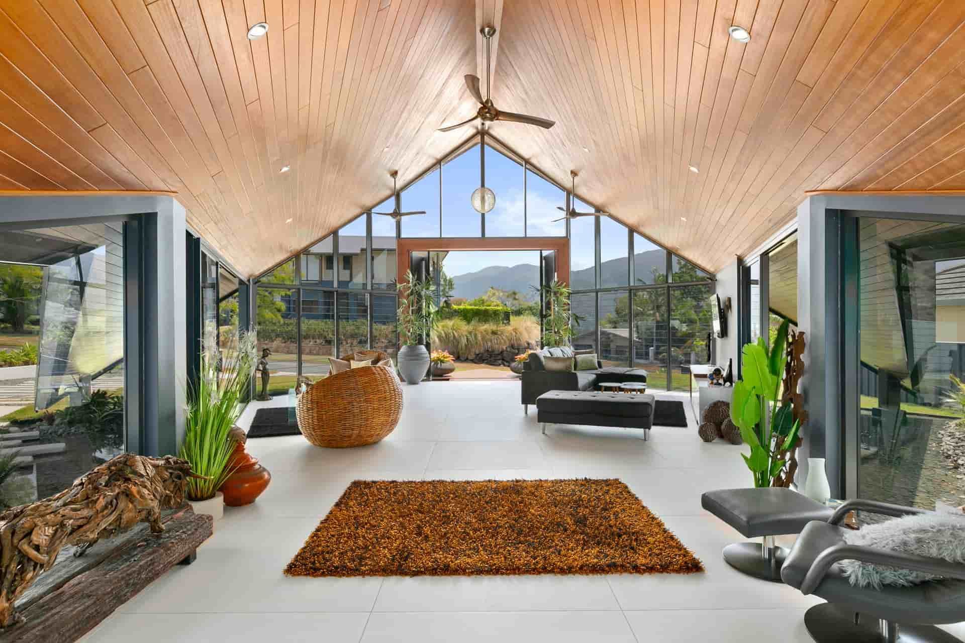 A Living Room With A Vaulted Ceiling And A Rug On The Floor — Omni Builders In Bungalow, QLD