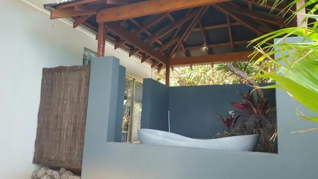 A Bathroom With a Bathtub Under a Gazebo — Omni Builders In Bungalow, QLD