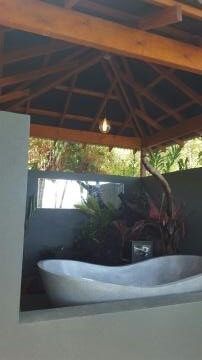 A Bathtub is Sitting Under a Gazebo in a Bathroom — Omni Builders In Bungalow, QLD