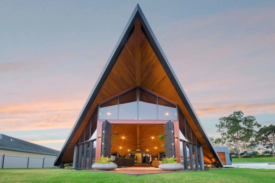 A House With a Triangle Shaped Roof and a Lot of Windows — Omni Builders In Bungalow, QLD