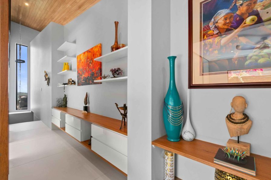 A Room With a Painting on the Wall and a Vase on the Shelf — Omni Builders In Bungalow, QLD