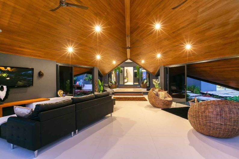 A Living Room With a Couch , Chairs , and a Ceiling Fan — Omni Builders In Bungalow, QLD