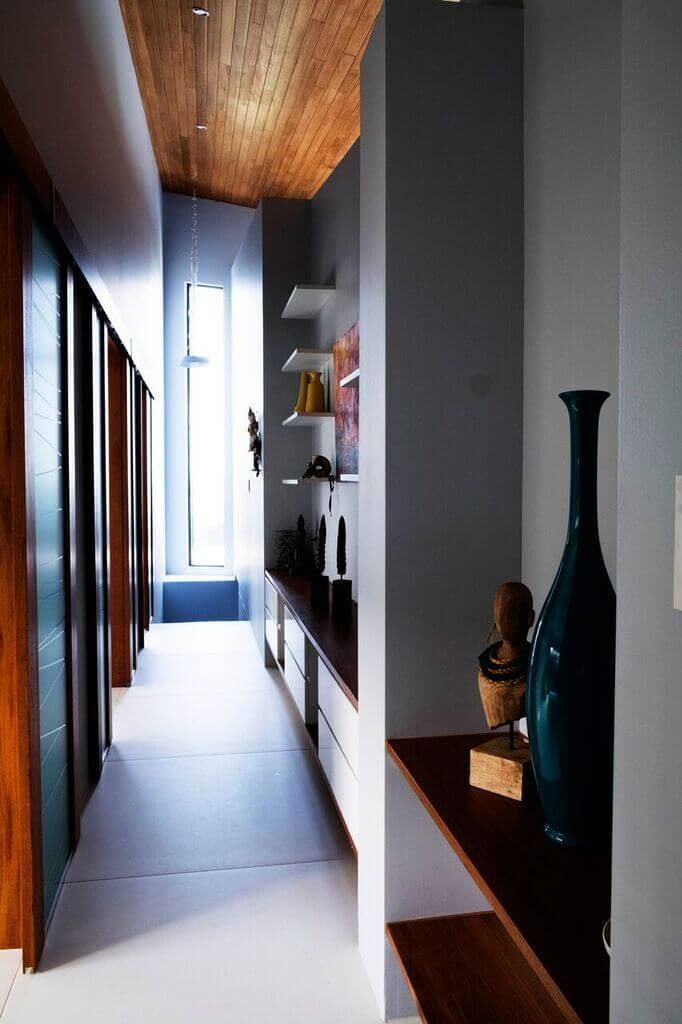 A Long Hallway With a Vase on a Shelf — Omni Builders In Bungalow, QLD