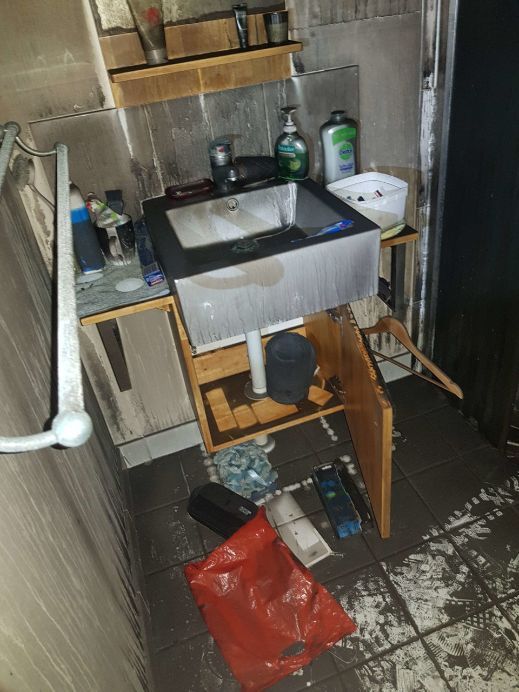 A Bathroom With a Sink and a Trash Bag on the Floor — Omni Builders In Bungalow, QLD