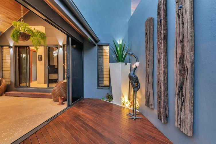 A House With a Sliding Glass Door and a Wooden Floor — Omni Builders In Bungalow, QLD