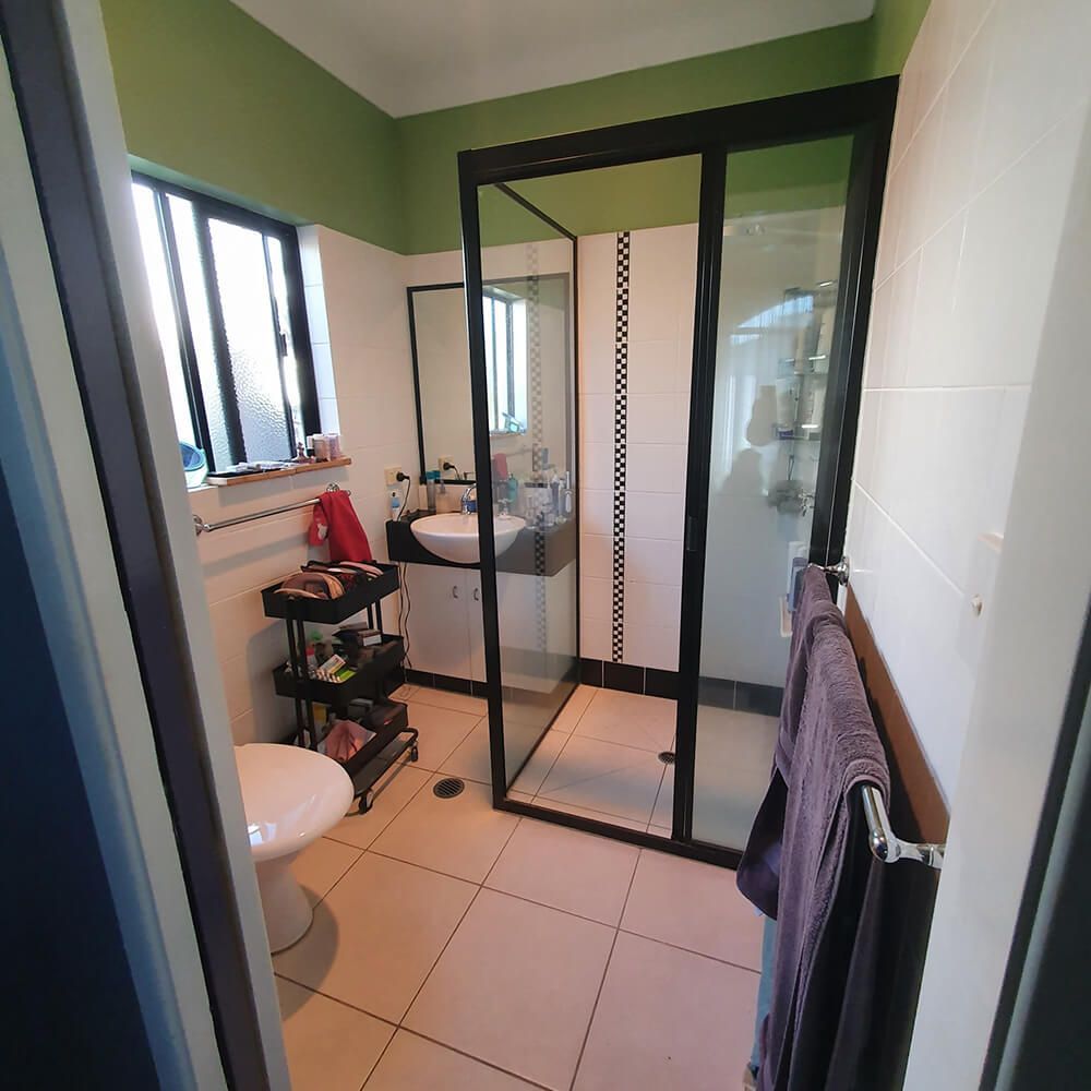 A Bathroom With a Toilet , Sink , and Shower — Omni Builders In Bungalow, QLD
