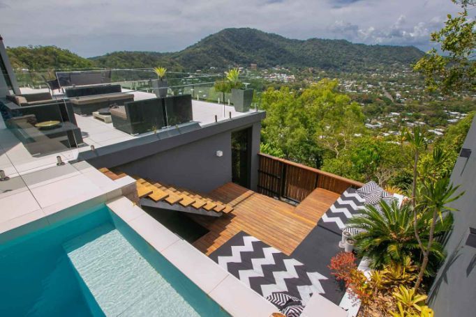 There is a Swimming Pool on the Roof of a House With a View of the Mountains — Omni Builders In Bungalow, QLD