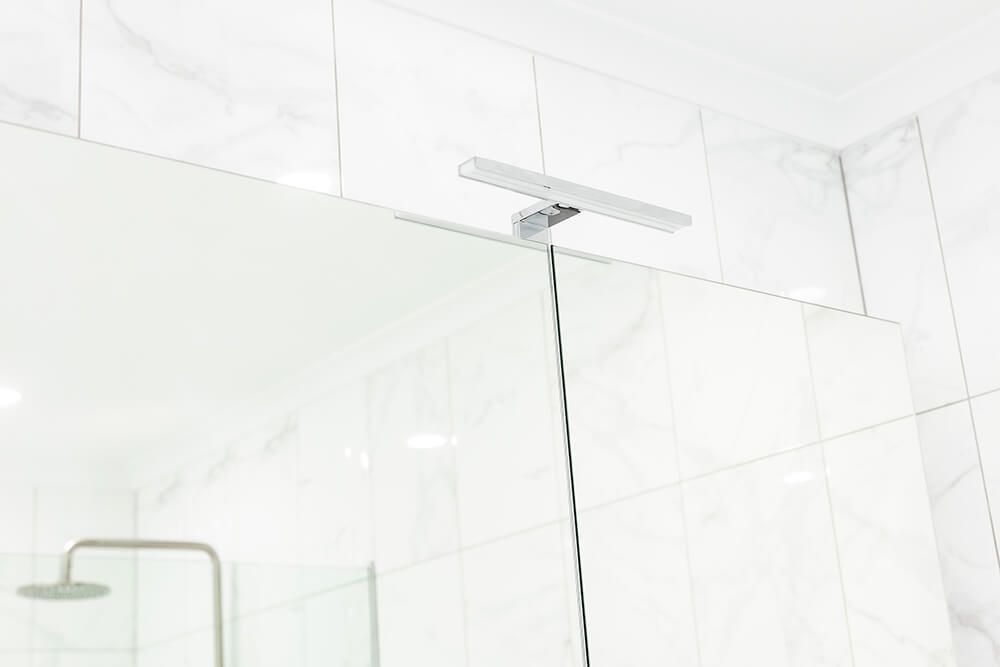 A Bathroom With a Shower and a Mirror — Omni Builders In Bungalow, QLD