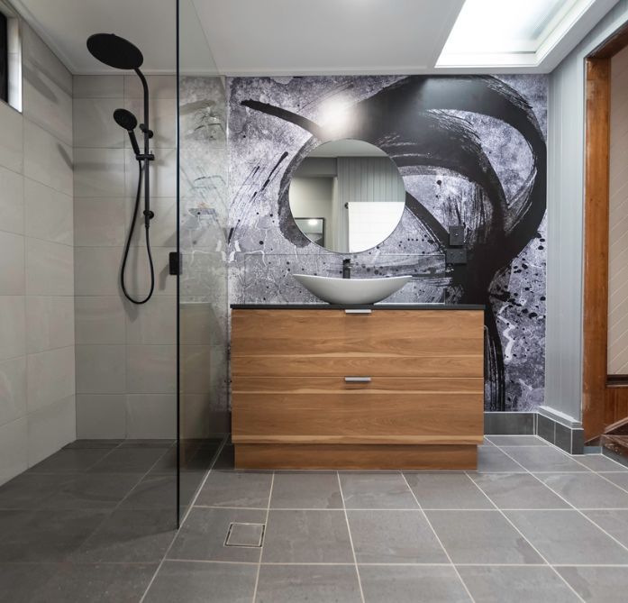 A Bathroom With a Sink a Mirror and a Shower — Omni Builders In Bungalow, QLD