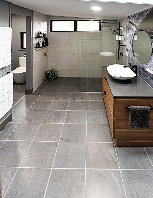 A Bathroom With a Sink , Toilet , Mirror and Walk in Shower — Omni Builders In Bungalow, QLD