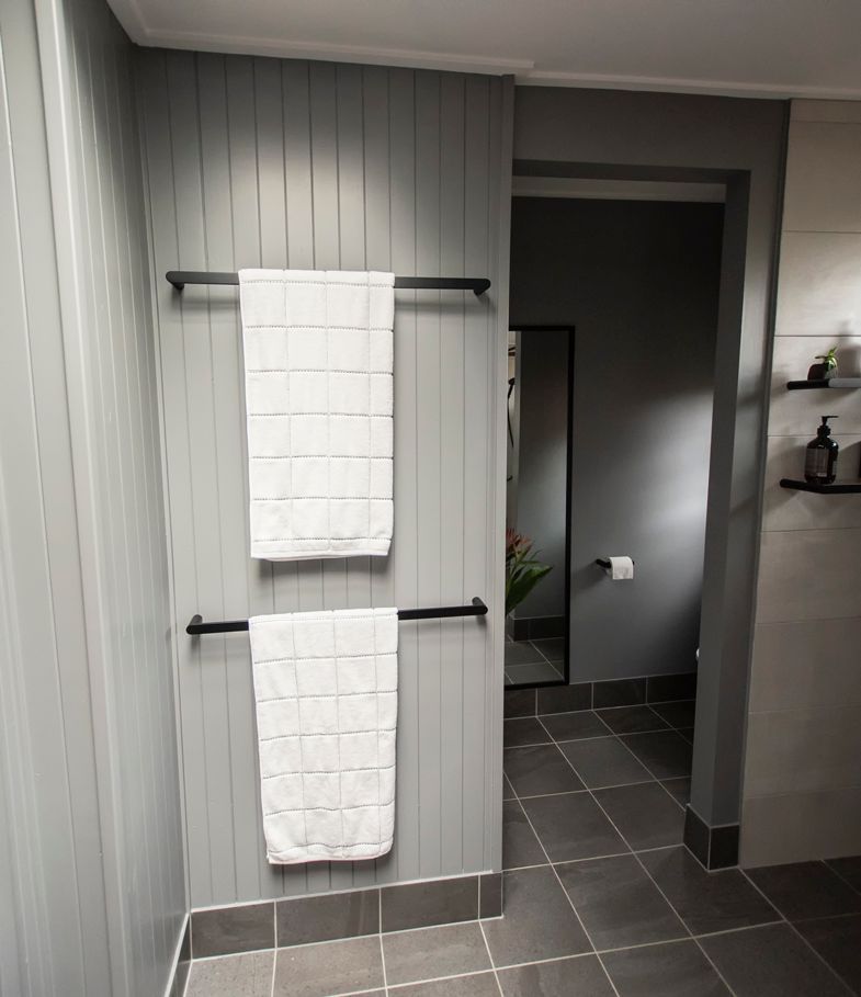 Two Towels Are Hanging on a Towel Rack in a Bathroom — Omni Builders In Bungalow, QLD