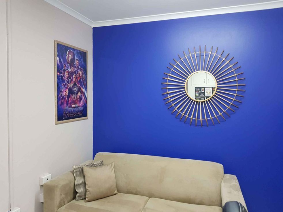 Living Room With a Couch and a Mirror on the Wall — Omni Builders In Bungalow, QLD