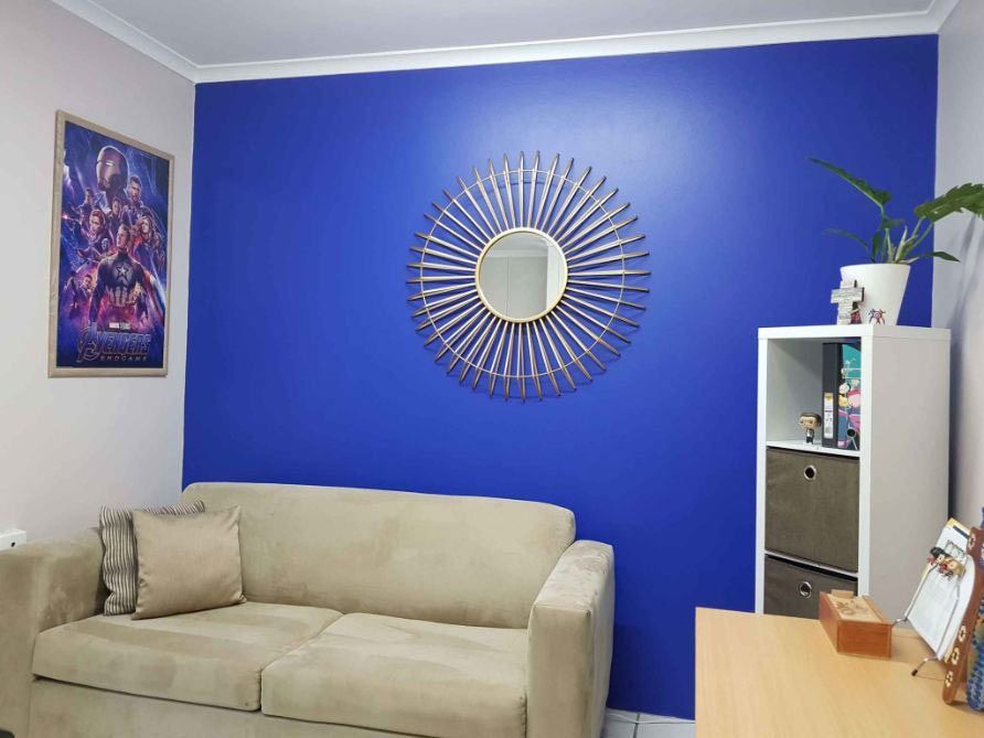 A Living Room With A Couch And Desk — Omni Builders In Bungalow, QLD
