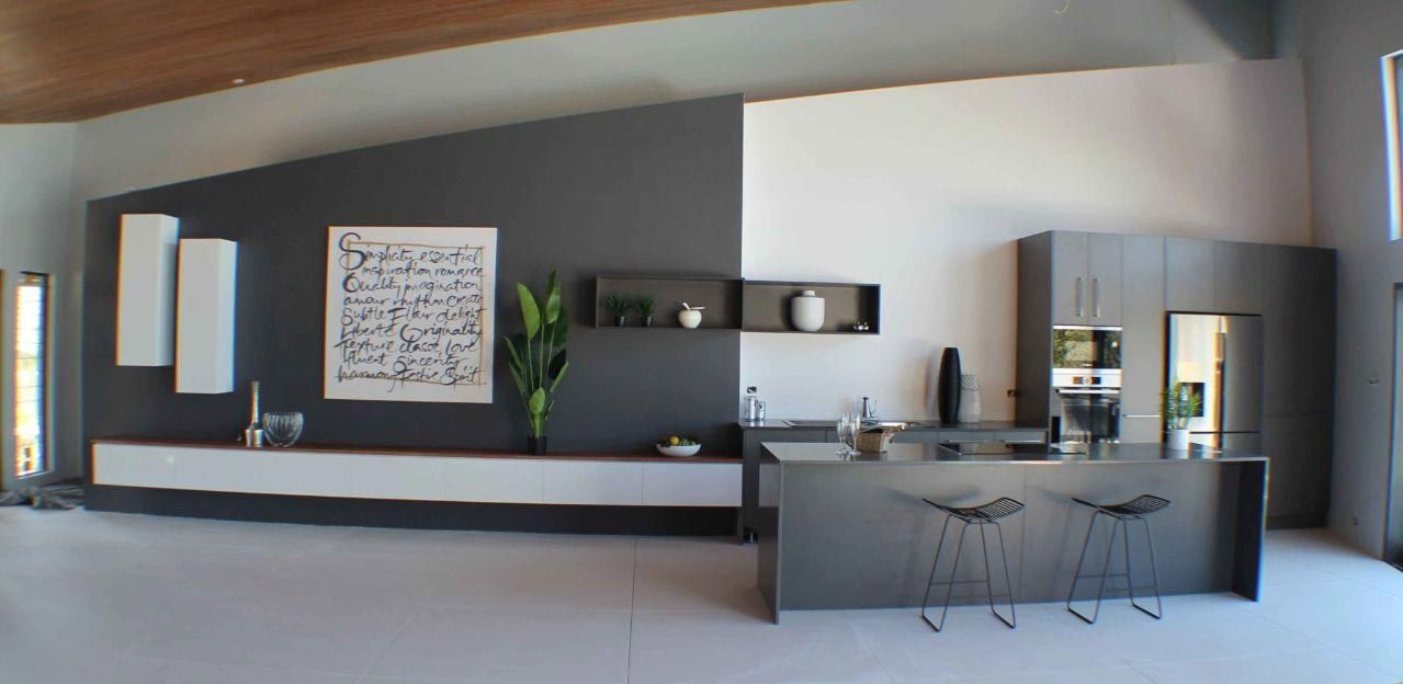 A Kitchen With A Large Island And Stools — Omni Builders In Bungalow, QLD