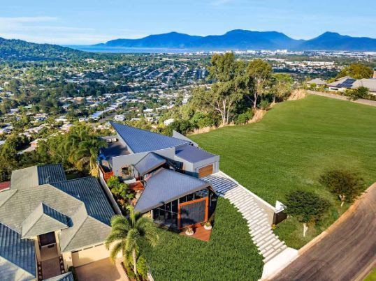 An Aerial View Of A House On A Hill With Mountains In The Background — Omni Builders In Bungalow, QLD