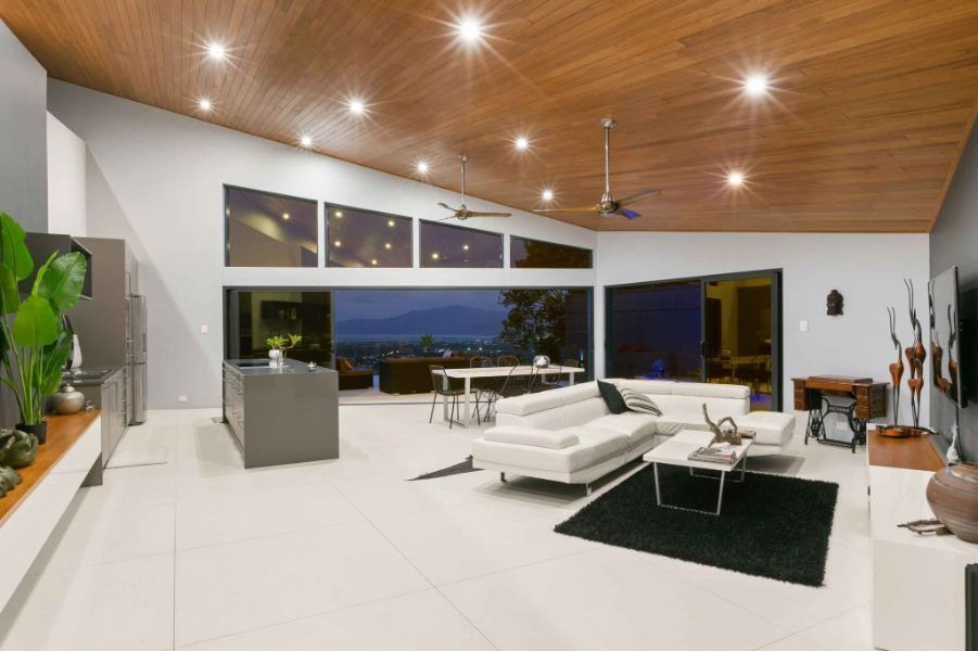 A Living Room With A White Couch And A Black Rug — Omni Builders In Bungalow, QLD