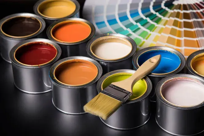 Paint cans in various colors with a paintbrush and color swatch.