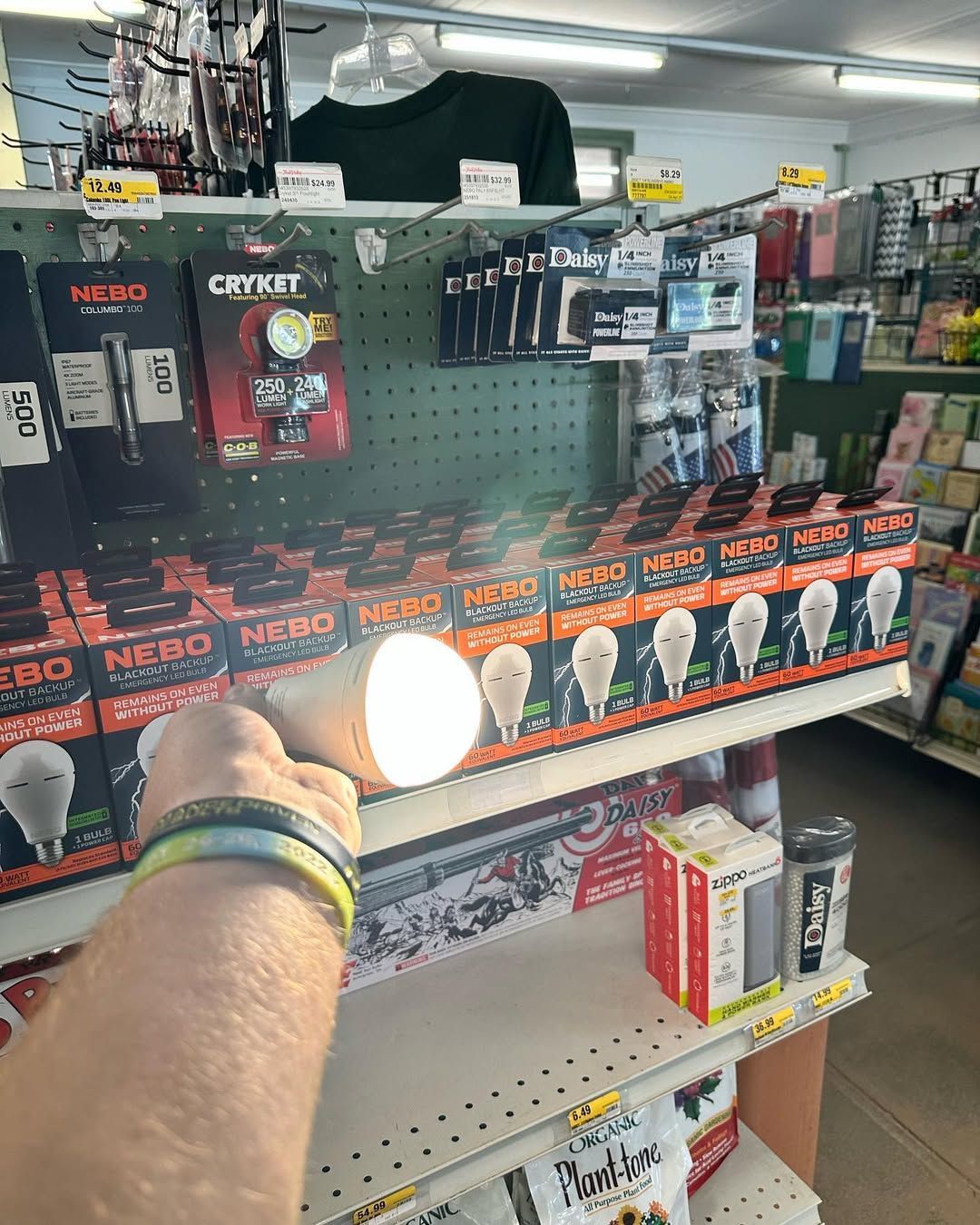 Person holding a bright flashlight, illuminating products on a store shelf.