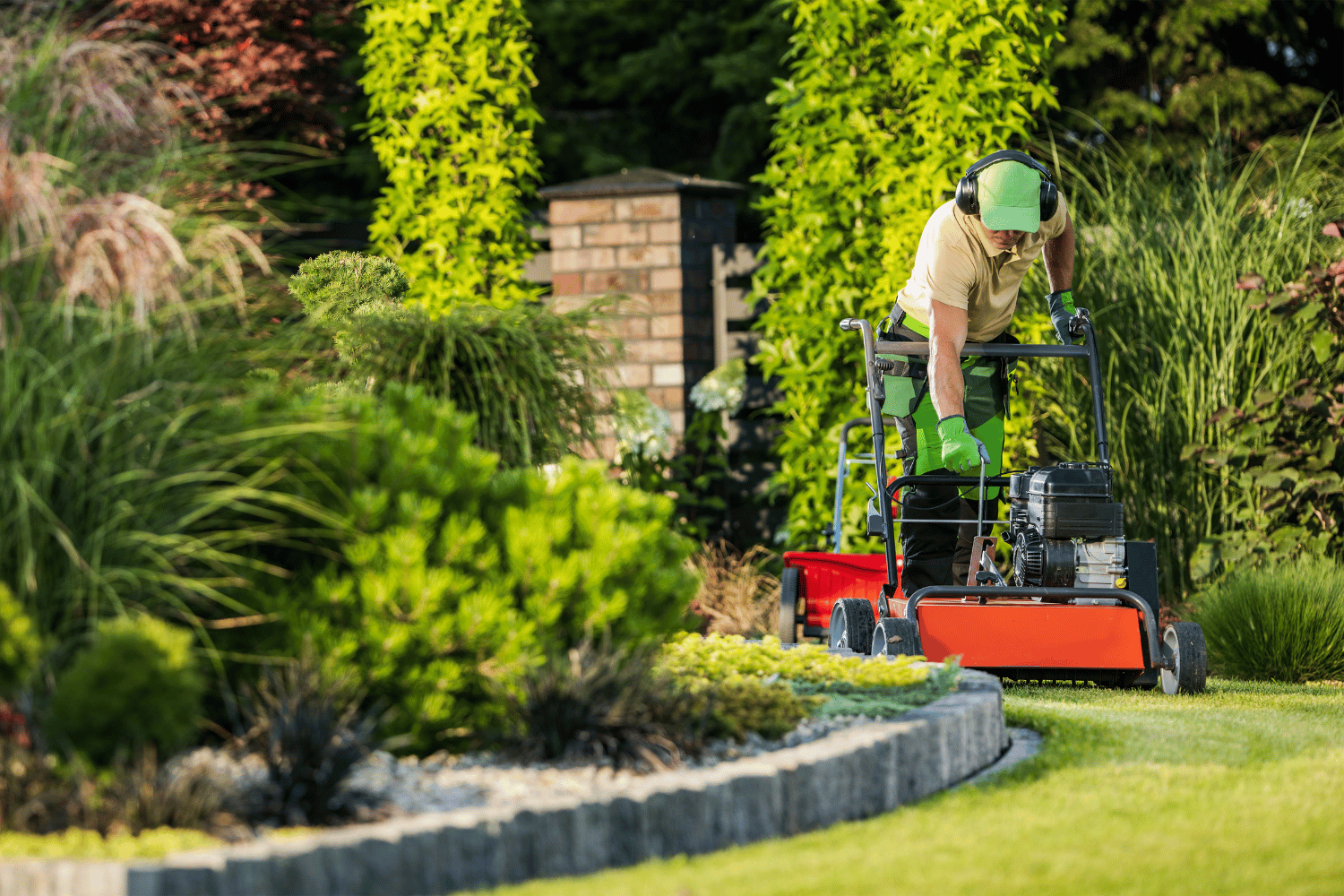 A man is riding a lawn mower in a garden.