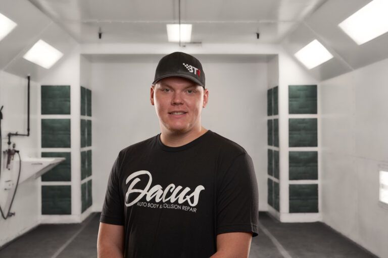 A man wearing a black shirt with the word Dacus on it