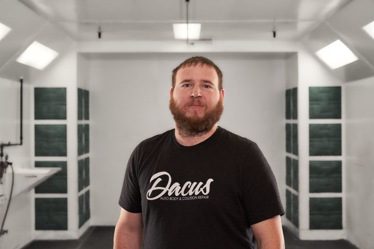 A man with a beard wearing a black shirt that says Dacus